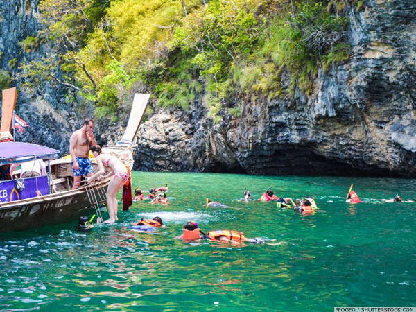 A group of people snorkeling from a boat off Phuket