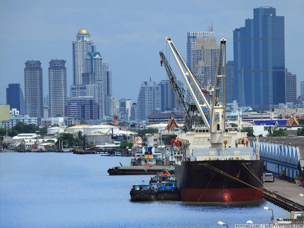 Cargo ship docked at Klong Toey Port in front of Bangkok’s skyline