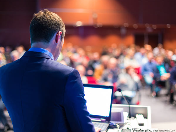 Speaker at a conference in front of delegates