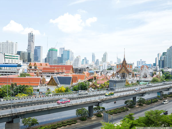 Taxis on a flyover in front of the Bangkok skyline